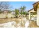 A serene backyard features a decorative fountain, lush landscaping, and a covered patio area, perfect for outdoor relaxation at 9160 Moose Country Pl, Las Vegas, NV 89178