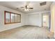 Spacious bedroom with carpet flooring, ceiling fan, and natural light from the window at 9160 Moose Country Pl, Las Vegas, NV 89178
