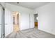Spacious bedroom featuring neutral carpet, and open doorways leading to a hallway and an adjacent bathroom at 9160 Moose Country Pl, Las Vegas, NV 89178