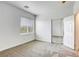 Bright bedroom with neutral carpet, window, and a closet with mirrored sliding doors at 9160 Moose Country Pl, Las Vegas, NV 89178