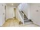 Bright foyer featuring tile flooring and a staircase leading to the upper level at 9160 Moose Country Pl, Las Vegas, NV 89178