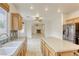 Open-concept kitchen with island overlooking the living room featuring a fireplace at 9160 Moose Country Pl, Las Vegas, NV 89178
