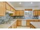 Kitchen featuring wooden cabinets, granite countertops, and stainless steel appliances at 9160 Moose Country Pl, Las Vegas, NV 89178