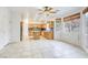 Open-concept kitchen with wooden cabinets, granite counters, island, and modern appliances, adjacent to the living space at 9160 Moose Country Pl, Las Vegas, NV 89178