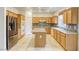 Well-equipped kitchen with stainless steel appliances, an island, and wood cabinetry at 9160 Moose Country Pl, Las Vegas, NV 89178