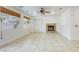 Spacious living room with tile flooring, a stone fireplace, and large windows at 9160 Moose Country Pl, Las Vegas, NV 89178