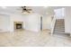 Open living room features a fireplace, tile flooring, and staircase at 9160 Moose Country Pl, Las Vegas, NV 89178