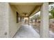 Covered patio with a ceiling fan, overlooking a landscaped backyard with mature trees and rock features at 9160 Moose Country Pl, Las Vegas, NV 89178