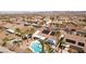 Expansive aerial view featuring a refreshing private pool, desert landscaping, mountain views, and solar panels at 1019 Amber Gate St, Henderson, NV 89002