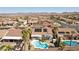 Expansive aerial view featuring a refreshing private pool, desert landscaping, mountain views, and solar panels at 1019 Amber Gate St, Henderson, NV 89002