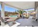 Covered patio offers serene views of the pool and landscaped backyard at 1019 Amber Gate St, Henderson, NV 89002