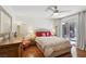 Inviting bedroom with a large bed, hardwood floors, and sliding glass door to the yard at 1019 Amber Gate St, Henderson, NV 89002