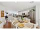 Open dining area with modern table, stainless steel refrigerator, and view to the living room at 1019 Amber Gate St, Henderson, NV 89002