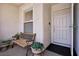 Inviting entryway featuring a cozy bench, beautiful potted plants, and a secure front door at 1019 Amber Gate St, Henderson, NV 89002