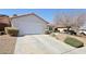 A well kept single-story home featuring desert landscaping and a spacious two-car garage at 1019 Amber Gate St, Henderson, NV 89002