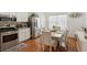 Eat-in kitchen features stainless appliances, wood floors, and an adjacent dining area at 1019 Amber Gate St, Henderson, NV 89002