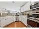 Bright kitchen showcases stainless appliances, granite counters, and wood-look flooring at 1019 Amber Gate St, Henderson, NV 89002