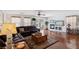 Spacious living room with a dark brown leather sectional sofa, fireplace, and hardwood floors at 1019 Amber Gate St, Henderson, NV 89002