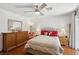 Comfortable main bedroom featuring hardwood floors, dresser, lamps, and ceiling fan at 1019 Amber Gate St, Henderson, NV 89002