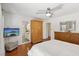 Bright main bedroom with ceiling fan, hardwood floors, and ensuite bathroom at 1019 Amber Gate St, Henderson, NV 89002
