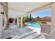 View of backyard pool and landscaping from covered patio with seating at 1019 Amber Gate St, Henderson, NV 89002