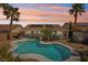 Backyard view of the private pool, tropical landscaping and covered patio of this charming single-Gathering home at 1019 Amber Gate St, Henderson, NV 89002