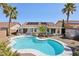A kidney-shaped pool and patio area are surrounded by palm trees in the backyard at 1019 Amber Gate St, Henderson, NV 89002