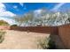The low-maintenance backyard features a gravel landscape and a brick perimeter wall at 10260 Hawks Wing St, Las Vegas, NV 89178