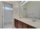 Bright bathroom with double sinks, a large mirror, and a separate tub/shower at 10260 Hawks Wing St, Las Vegas, NV 89178