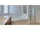 This bathroom features a modern soaking tub and a separate glass-enclosed shower at 10260 Hawks Wing St, Las Vegas, NV 89178