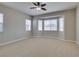 Bedroom with neutral carpet, ceiling fan, and bay window seating area at 10260 Hawks Wing St, Las Vegas, NV 89178