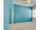 Bedroom with blue accent wall, ceiling fan, and carpet at 10260 Hawks Wing St, Las Vegas, NV 89178