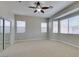 Spacious carpeted bedroom with sliding mirror door closet and multiple windows at 10260 Hawks Wing St, Las Vegas, NV 89178