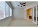 Spacious bedroom features carpet, ceiling fan and windows providing ample natural light at 10260 Hawks Wing St, Las Vegas, NV 89178