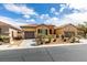Inviting single-story residence with a two-car garage and beautifully landscaped front yard under a blue sky at 10260 Hawks Wing St, Las Vegas, NV 89178