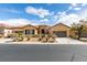Beautiful single-story home featuring a tile roof, three-car garage and desert landscaping at 10260 Hawks Wing St, Las Vegas, NV 89178