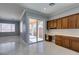 Bright kitchen area with sliding door to patio, offering ample cabinet space and a built-in desk area at 10260 Hawks Wing St, Las Vegas, NV 89178