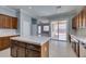 Kitchen island view offering access to patio with wooden cabinets and stainless steel appliances at 10260 Hawks Wing St, Las Vegas, NV 89178