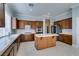Well-equipped kitchen with stainless steel appliances, an island, ample counter space and abundant wood cabinetry at 10260 Hawks Wing St, Las Vegas, NV 89178