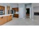 Kitchen featuring wooden island, stainless steel refrigerator, and doorway to rooms with fireplace at 10260 Hawks Wing St, Las Vegas, NV 89178