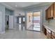 Open kitchen view showing access to outdoor patio and living areas, with light tile flooring at 10260 Hawks Wing St, Las Vegas, NV 89178