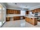 Modern kitchen with wood cabinetry, stainless steel appliances, and marble floors at 10260 Hawks Wing St, Las Vegas, NV 89178