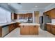 Bright kitchen with a central island, stainless steel appliances, and wood cabinets at 10260 Hawks Wing St, Las Vegas, NV 89178