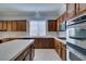 Gourmet kitchen with stainless steel double oven, built-in microwave, and ample wooden cabinetry at 10260 Hawks Wing St, Las Vegas, NV 89178