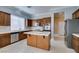 Spacious kitchen with stainless steel appliances, generous counter space, and light-colored tiled flooring at 10260 Hawks Wing St, Las Vegas, NV 89178