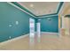 An open living area featuring dual chandeliers, archways, and travertine flooring at 10260 Hawks Wing St, Las Vegas, NV 89178