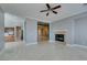 Spacious living room with a fireplace and marble floors, leading into other living areas at 10260 Hawks Wing St, Las Vegas, NV 89178