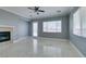 Cozy living room with fireplace, marble floors and a glass door for ample natural light at 10260 Hawks Wing St, Las Vegas, NV 89178