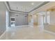 Open living space with marble floors, elegant columns, and a smooth transition into the adjacent kitchen area at 10260 Hawks Wing St, Las Vegas, NV 89178