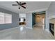 Living room with fireplace and direct view of the kitchen and dining area at 10260 Hawks Wing St, Las Vegas, NV 89178